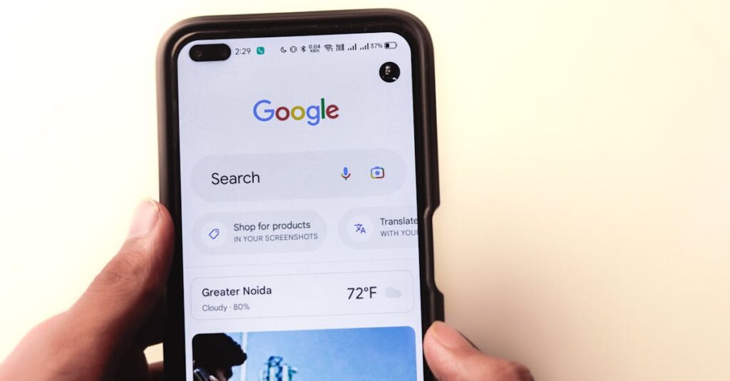 A close-up of a hand holding a smartphone with Google search displayed on the screen.